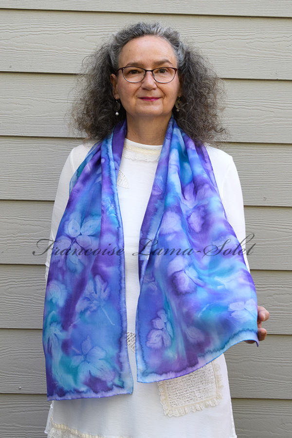 Women's wearable art lightweight summer silk scarf hand painted in the shades turquoise teal, blue and purple and sun printed with leaves - Blue Violet